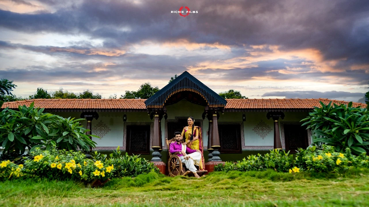 Prewedding photoshoot sitting in front of the vintage house pose in traditional wear