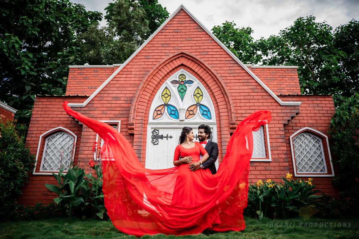 Prewedding photoshoot standing pose and red gown flying