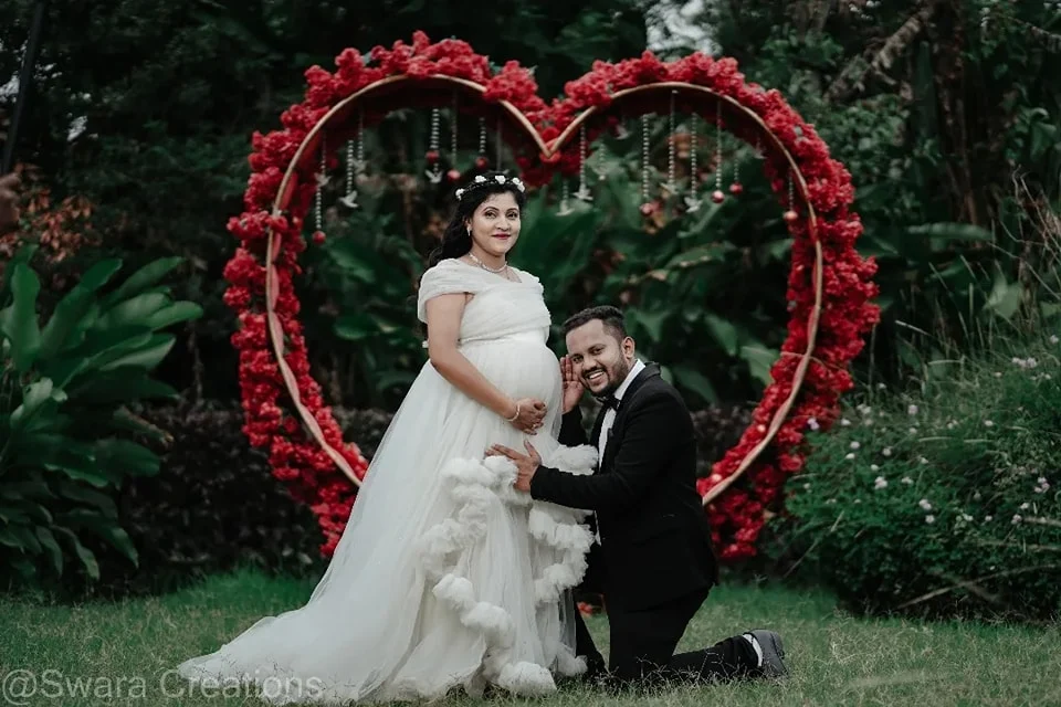 maternity photoshoot pose with husband in white gown