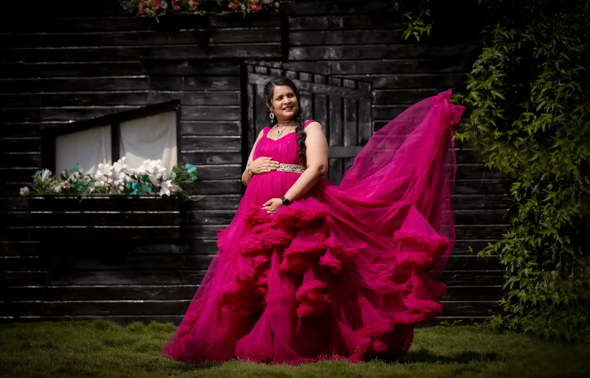 maternity photoshoot pose in pink gown